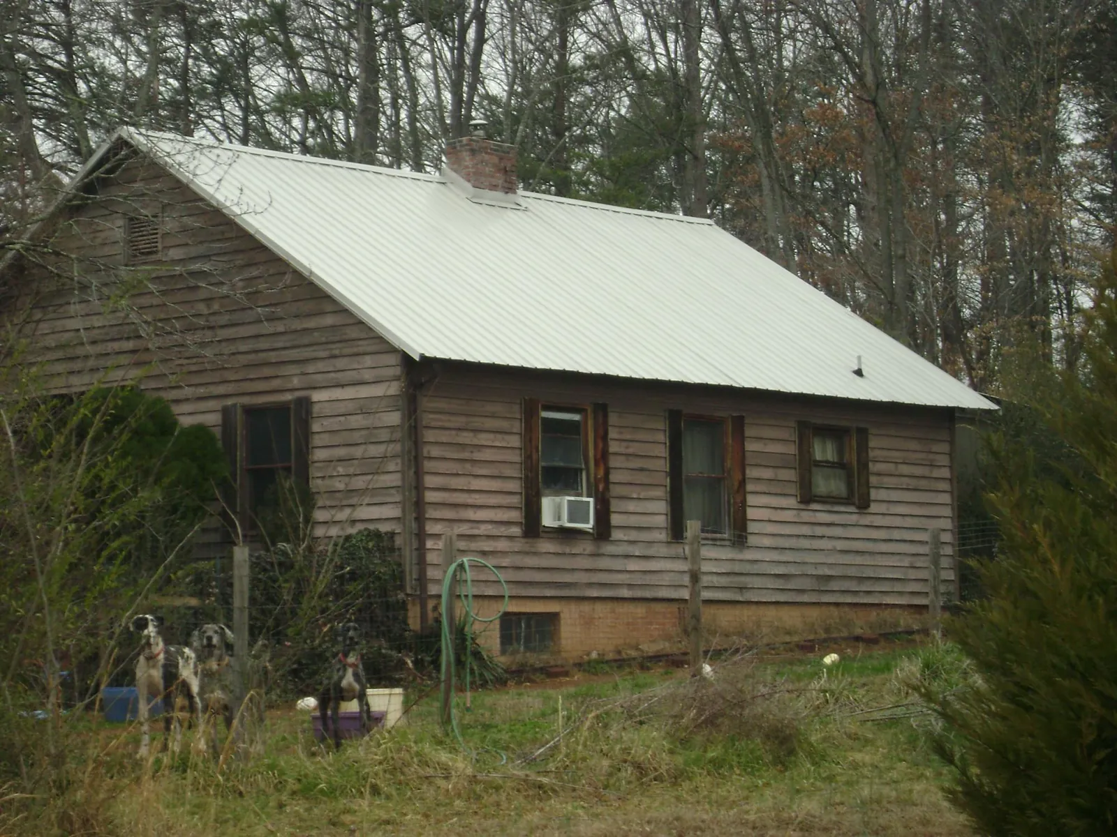 White metal roof on an old wood sided farmhouse, from a Metal Roof Installation job in Harrington